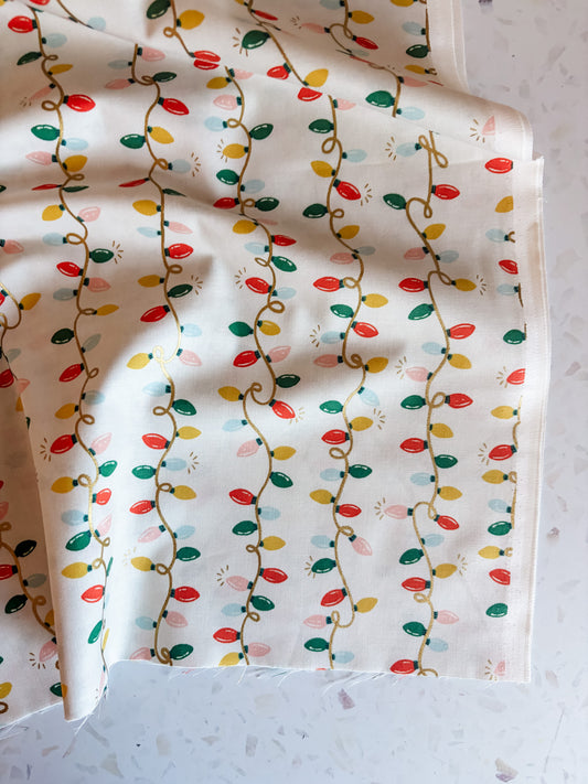 Holiday Classics Holiday Lights Cotton Fabric in Cream Metallic
