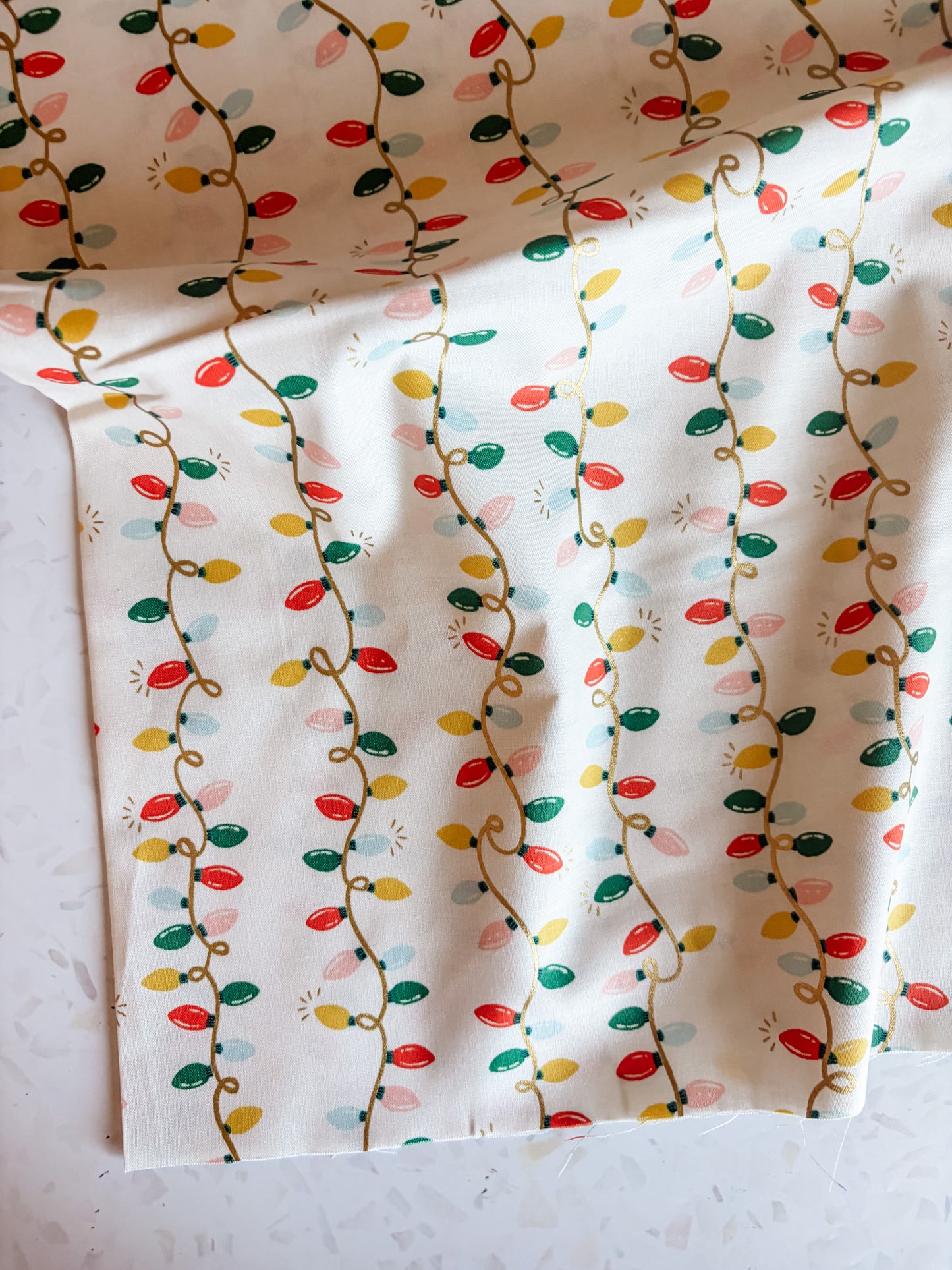 Holiday Classics Holiday Lights Cotton Fabric in Cream Metallic