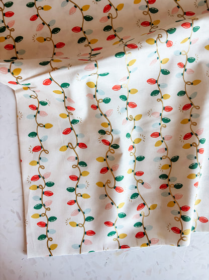 Holiday Classics Holiday Lights Cotton Fabric in Cream Metallic