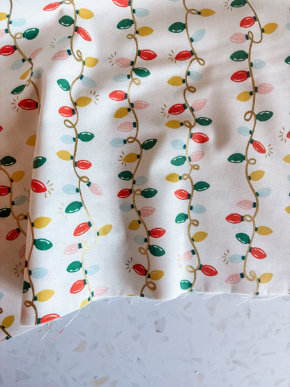 Holiday Classics Holiday Lights Cotton Fabric in Cream Metallic