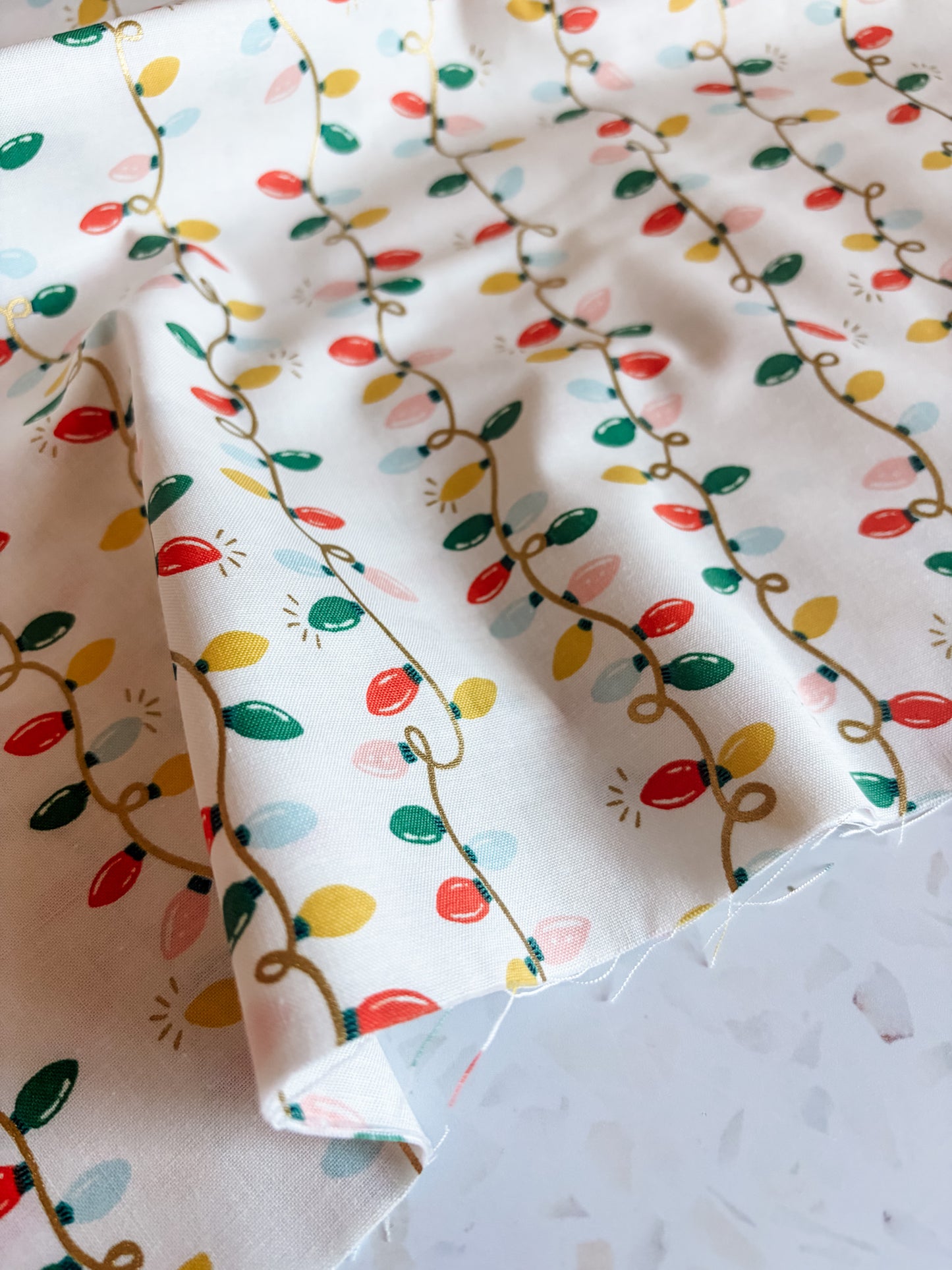 Holiday Classics Holiday Lights Cotton Fabric in Cream Metallic