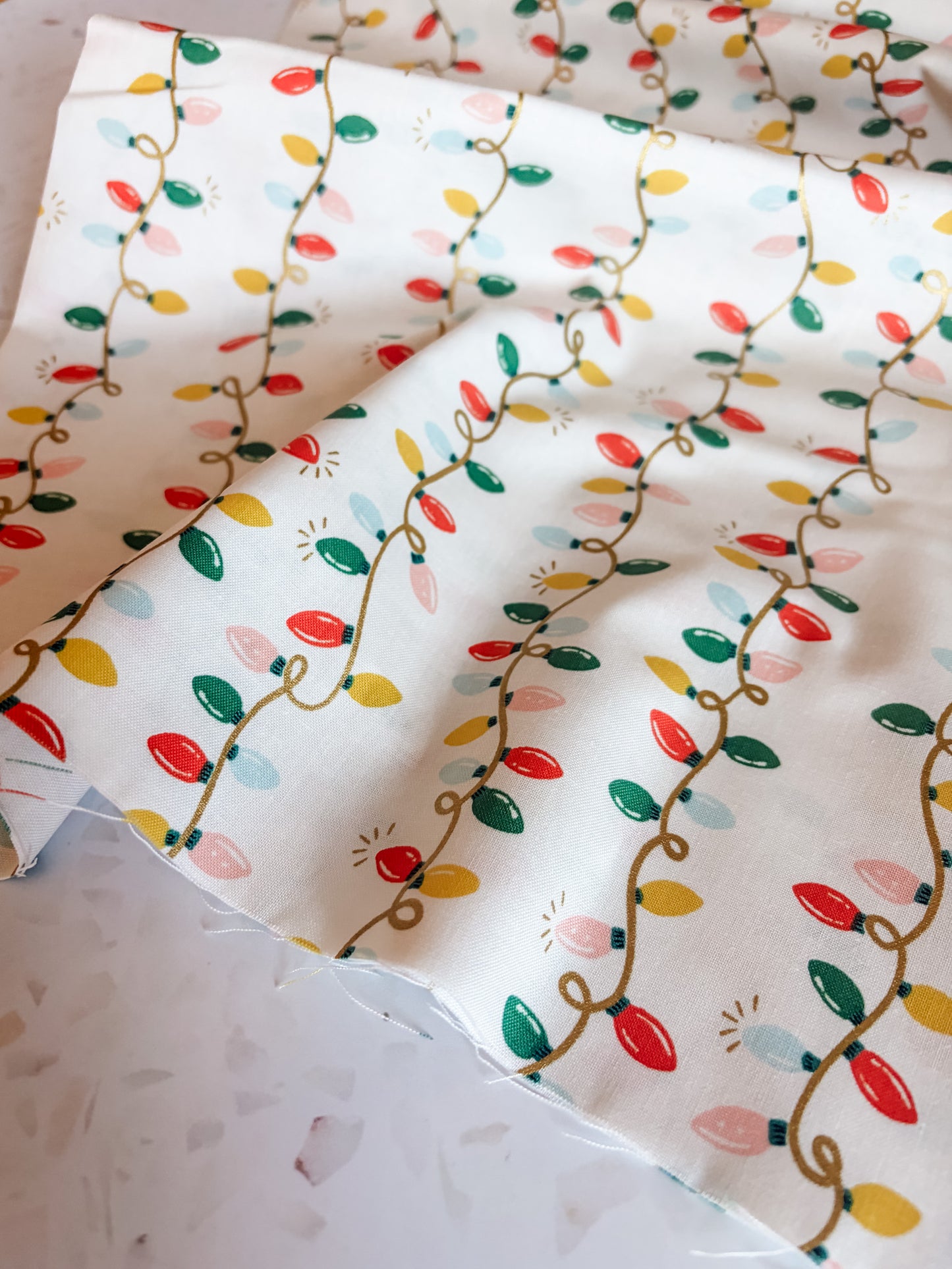 Holiday Classics Holiday Lights Cotton Fabric in Cream Metallic