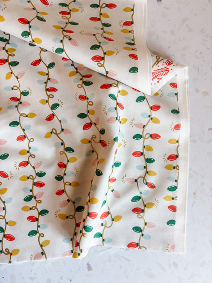Holiday Classics Holiday Lights Cotton Fabric in Cream Metallic